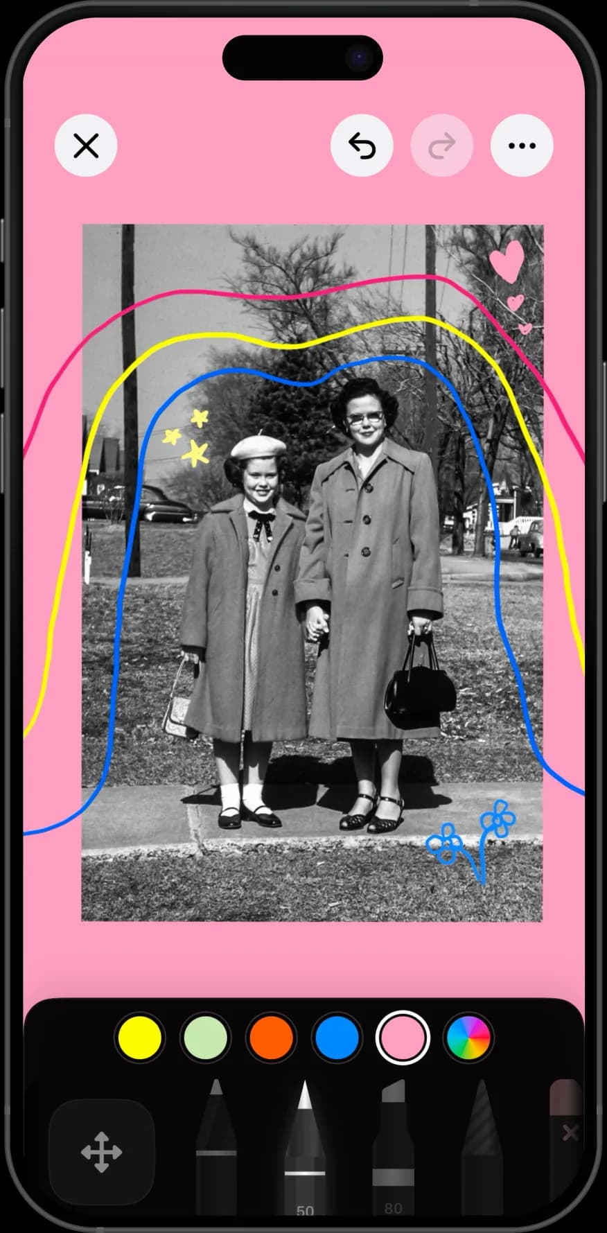 A Nooka journal page on iPhone: a black-and-white family photo on a pink background, ringed with hand-drawn pink, yellow, and blue lines and small doodled hearts and flowers.